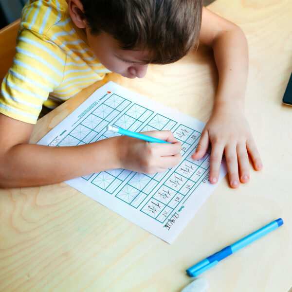 Child writing on Mi Zi Ge Chinese Writing Paper